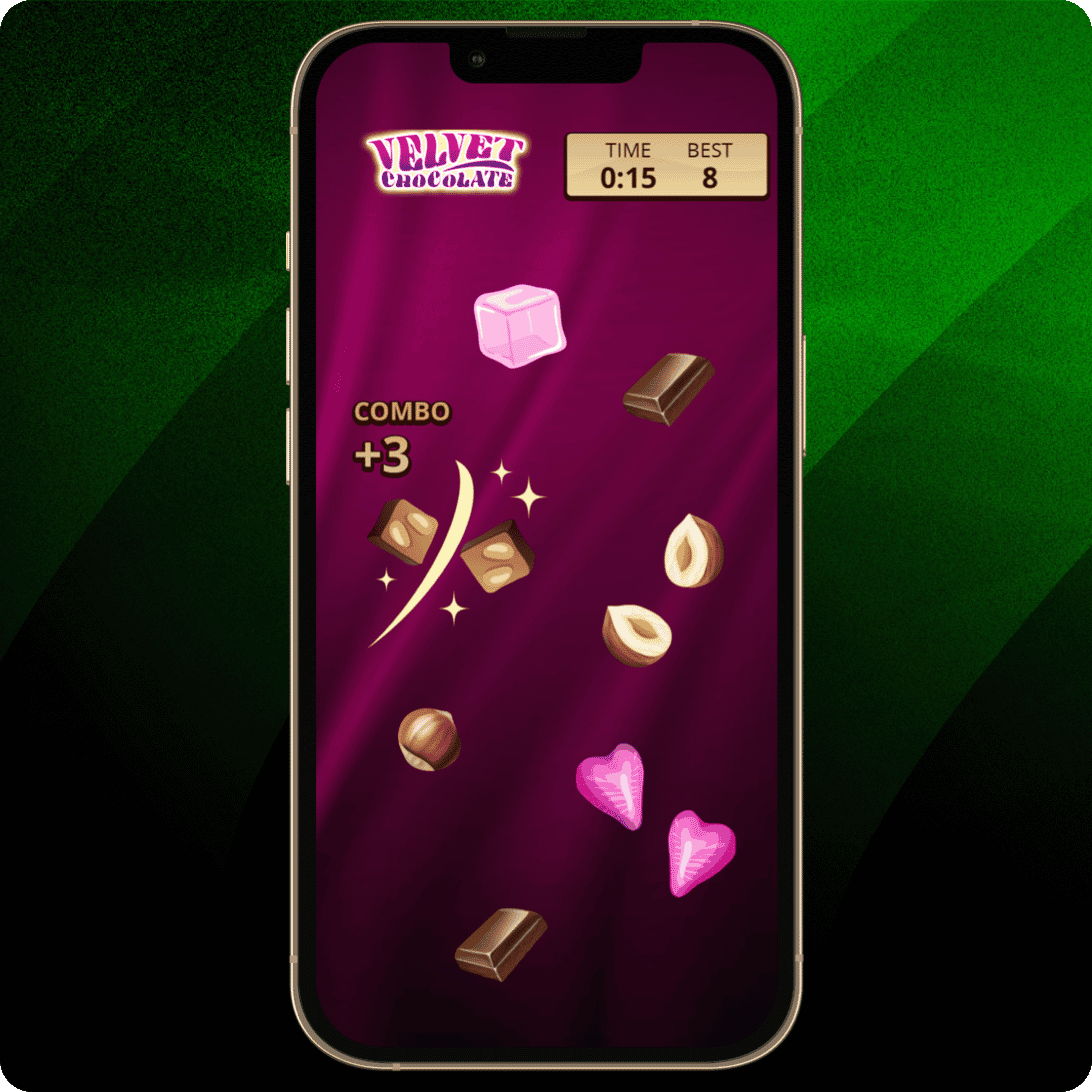 Smartphone mit einem Spiel vor dunkelmagenta Hintergrund mit Schokoladenstücken, Nüssen und pinkfarbenen Herzen sowie Velvet-Chocolate-Logo, Timer und Punktestand.