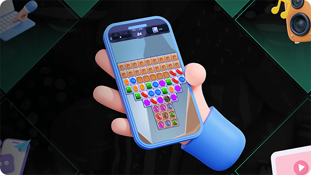 A stylized illustration of a hand holding a smartphone showing a candy puzzle game with colorful pieces arranged in rows.