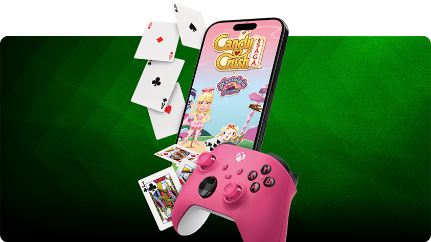 Pinkfarbener XBOX-Controller vor einem Smartphone mit Candy Crush Saga, umgeben von Spielkarten, vor einem grün gestreiften Hintergrund.
