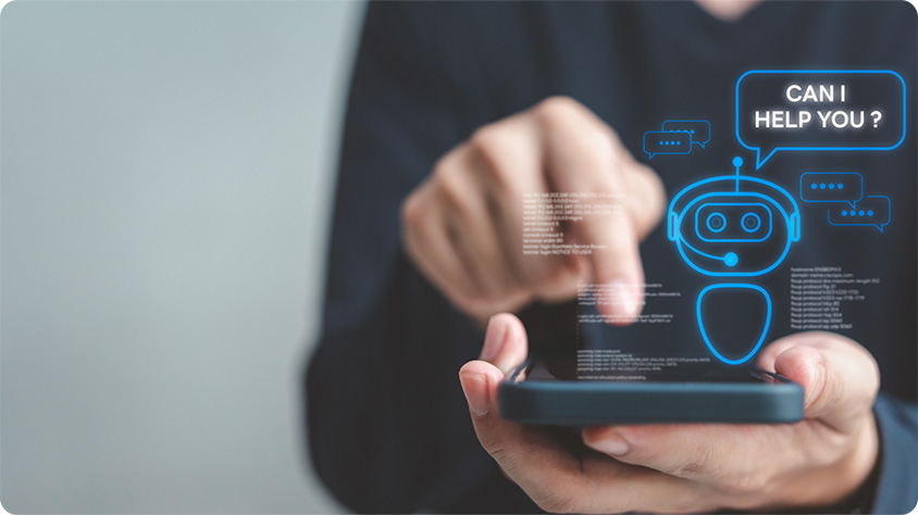A person is holding a smartphone and interacting with a digital interface. A holographic chatbot icon with the text "CAN I HELP YOU?"